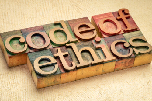 code of ethics text in vintage letterpress wood type printing blocks stained by color inks, values, ethical principles, and standards concept
