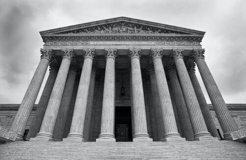 The Supreme Court building in Washington DC. in black and white.